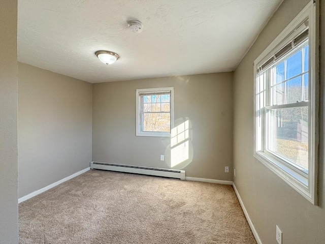 unfurnished room featuring a baseboard radiator, carpet floors, and a wealth of natural light