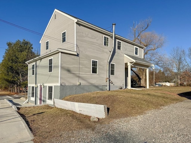 view of side of home with a lawn