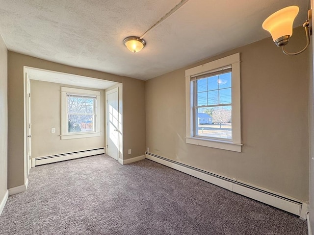 unfurnished room featuring a baseboard radiator, carpet flooring, and a textured ceiling