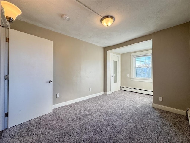 carpeted empty room with a baseboard heating unit and a textured ceiling