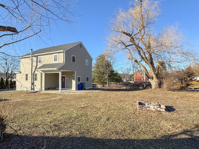 rear view of property with a yard and a patio