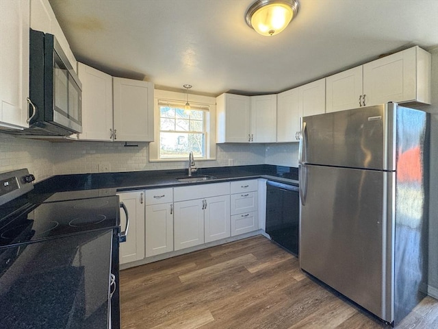 kitchen with white cabinetry, sink, and stainless steel appliances