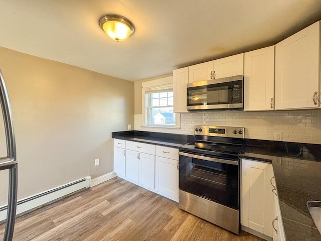 kitchen with light hardwood / wood-style flooring, a baseboard radiator, stainless steel appliances, and white cabinets