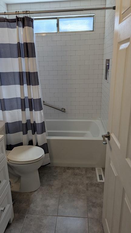 92 Santuit Pond Rd, Mashpee, MA 02649 - bathroom featuring toilet, shower / bath combo with shower curtain, vanity, and tile patterned floors