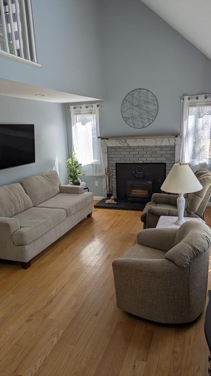 92 Santuit Pond Rd, Mashpee, MA 02649 - living room with high vaulted ceiling, a brick fireplace, and wood finished floors