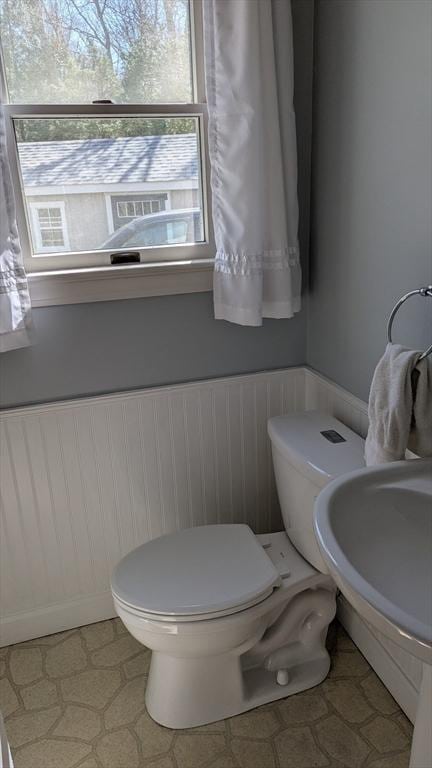 92 Santuit Pond Rd, Mashpee, MA 02649 - half bathroom with toilet, wainscoting, and a sink