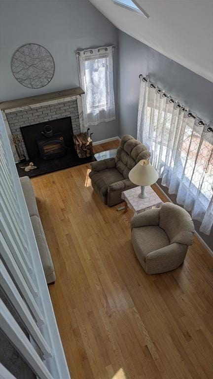 92 Santuit Pond Rd, Mashpee, MA 02649 - living area with vaulted ceiling, wood finished floors, a stone fireplace, and a skylight