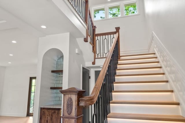 61 Westbourne Rd, Newton, MA 02459 - staircase with a high ceiling, recessed lighting, and arched walkways