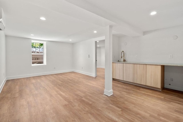 61 Westbourne Rd, Newton, MA 02459 - below grade area featuring a sink, light wood-style floors, recessed lighting, and baseboards