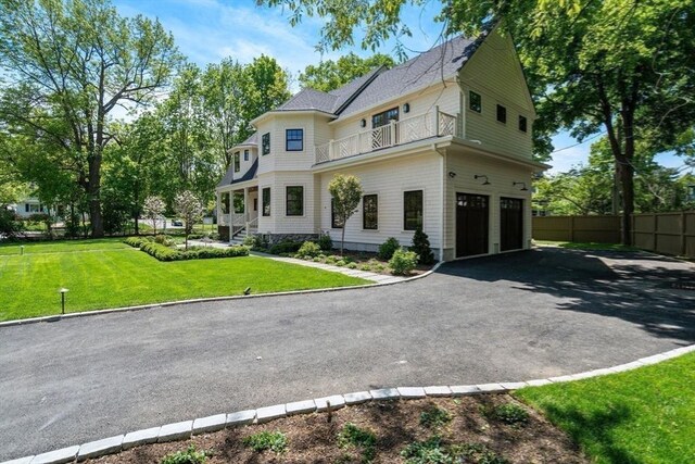 61 Westbourne Rd, Newton, MA 02459 - victorian-style house featuring a balcony, a garage, driveway, and roof with shingles