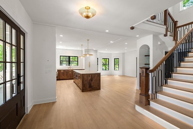 61 Westbourne Rd, Newton, MA 02459 - foyer entrance featuring stairs, light wood finished floors, baseboards, arched walkways, and recessed lighting