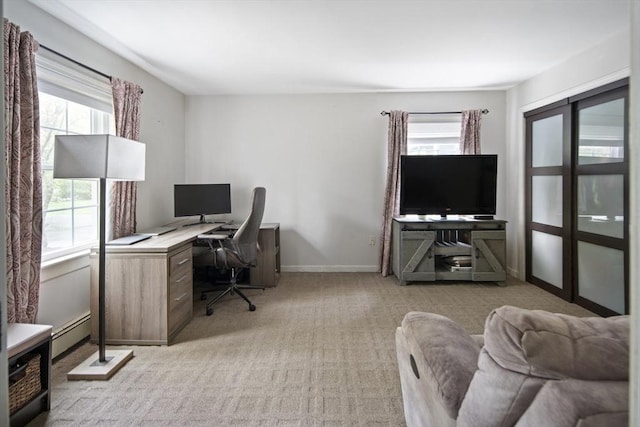 office with light carpet, plenty of natural light, a baseboard heating unit, and baseboards