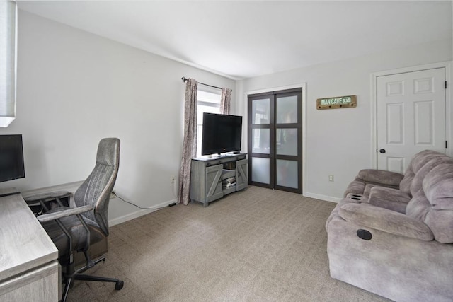 office area with light carpet and baseboards