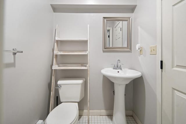 half bath with toilet and baseboards