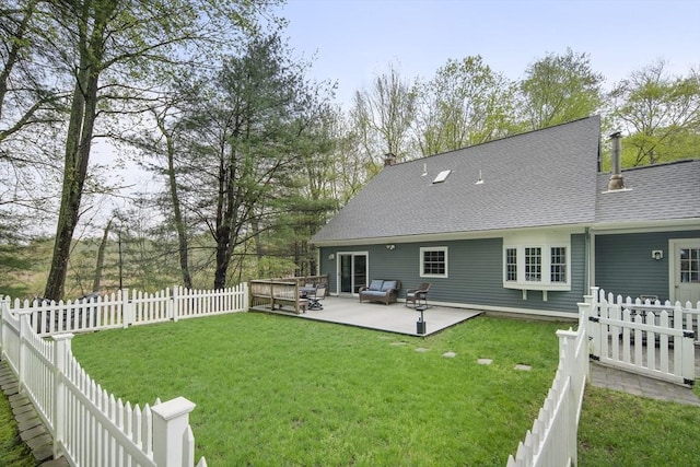 rear view of house with a patio, a shingled roof, and an outdoor living space