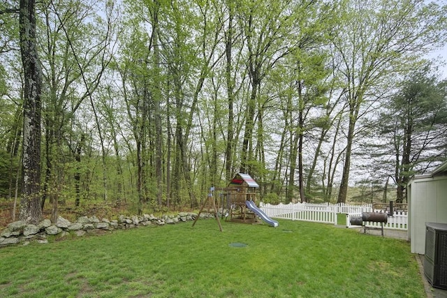 view of yard featuring a playground and central AC unit