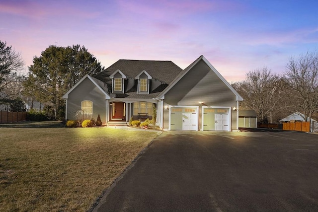 view of front of house featuring a garage and a yard