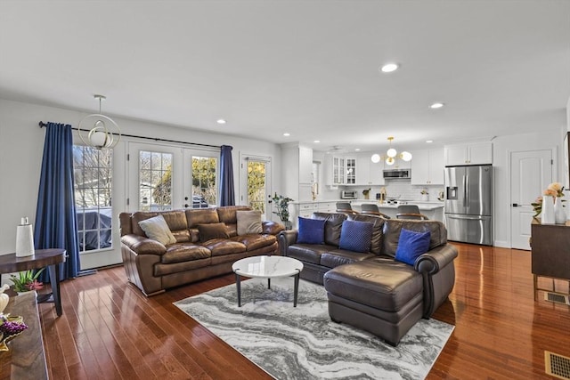 living room featuring french doors and dark hardwood / wood-style flooring