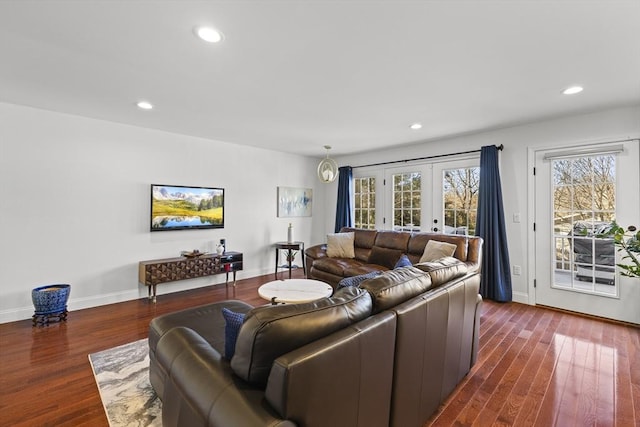 living room with dark hardwood / wood-style flooring and french doors