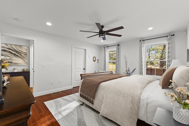 bedroom with ceiling fan and dark wood-type flooring