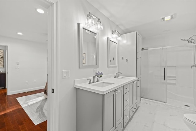 bathroom with toilet, walk in shower, wood-type flooring, and vanity