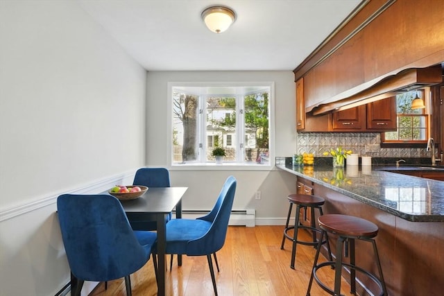 dining space featuring a healthy amount of sunlight and light wood-style flooring