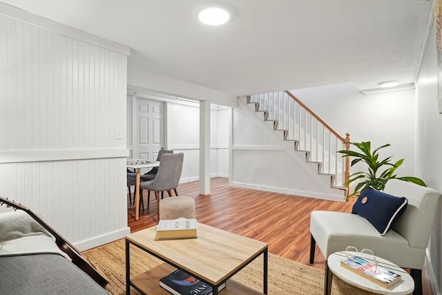 living room featuring stairs and light wood finished floors