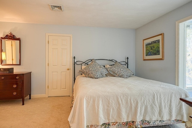 carpeted bedroom with multiple windows