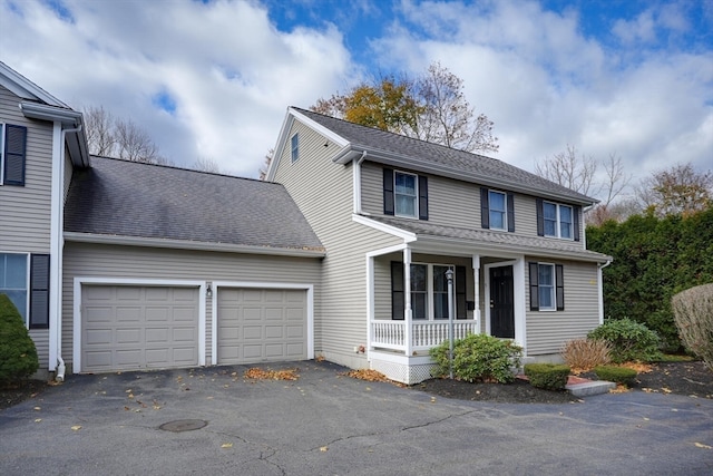 view of front of home featuring a porch and a garage