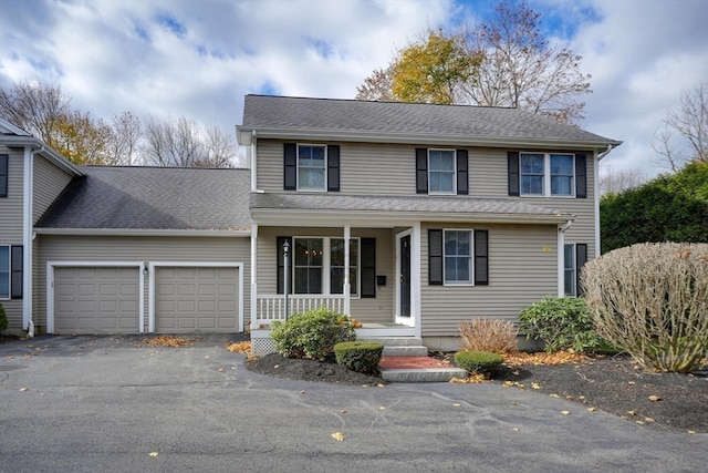 view of front of property featuring covered porch and a garage