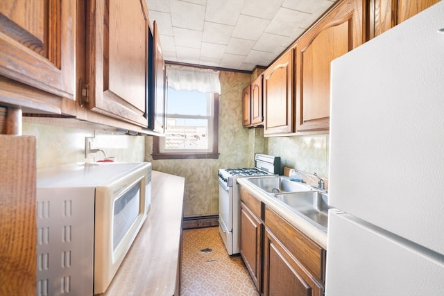 kitchen with sink and white appliances