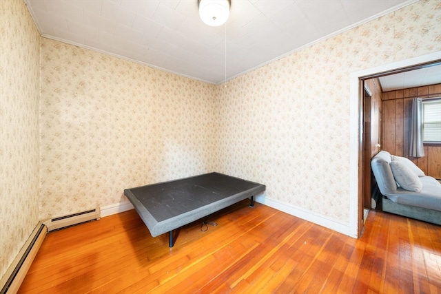 miscellaneous room featuring hardwood / wood-style flooring, ornamental molding, and a baseboard radiator