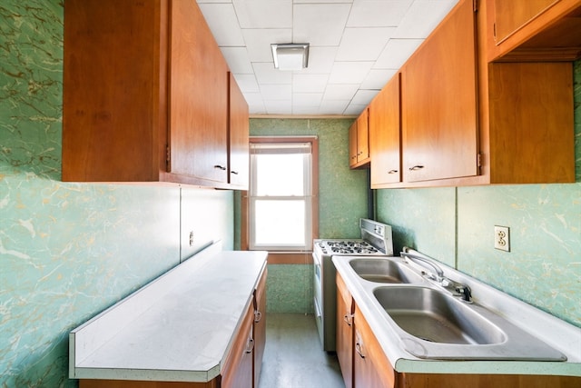 kitchen featuring washer / clothes dryer and sink