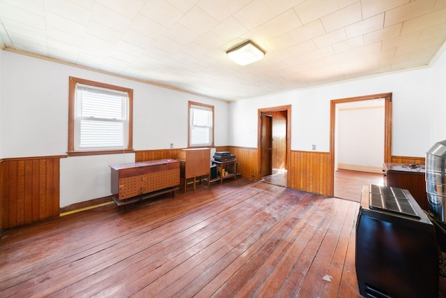 miscellaneous room with wooden walls and hardwood / wood-style floors