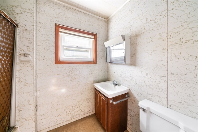 bathroom featuring walk in shower, vanity, toilet, and crown molding