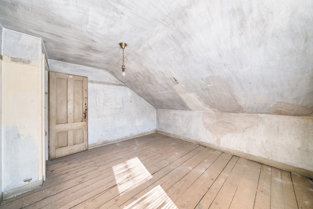 bonus room featuring light hardwood / wood-style flooring and vaulted ceiling