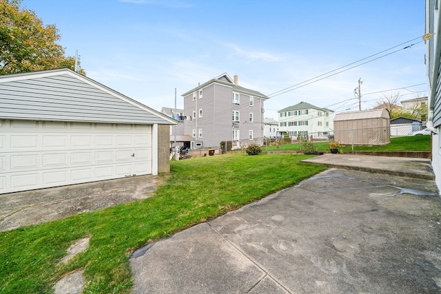 view of yard featuring a garage and an outbuilding