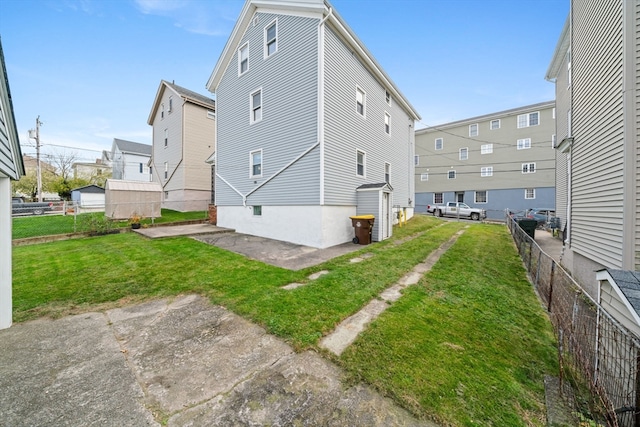 back of house featuring a patio area and a yard