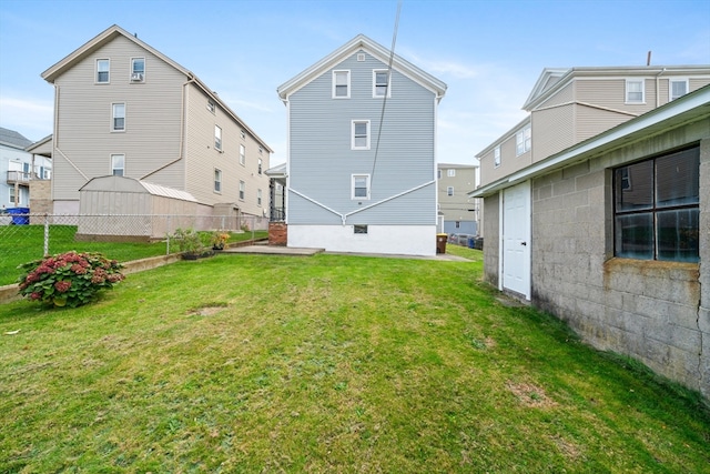 rear view of property with a yard and a patio area