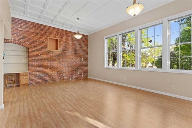42 Phillips Rd Unit 1, Holden, MA 01520 - unfurnished living room featuring light wood-style flooring, baseboards, and brick wall