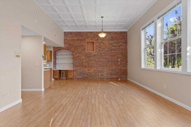 42 Phillips Rd Unit 1, Holden, MA 01520 - unfurnished living room featuring brick wall, light wood-style flooring, and baseboards