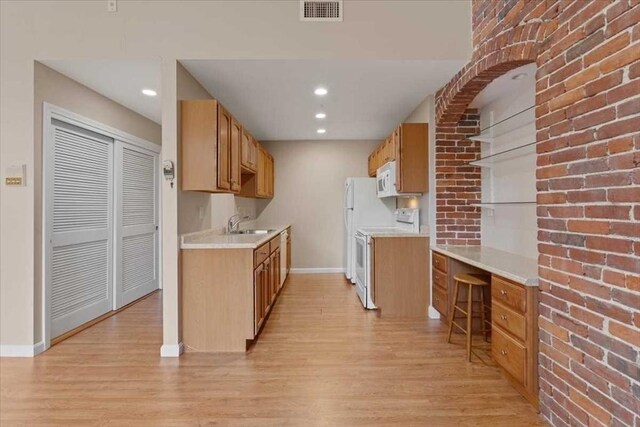 42 Phillips Rd Unit 1, Holden, MA 01520 - kitchen featuring white appliances, baseboards, light wood-style flooring, light countertops, and a sink
