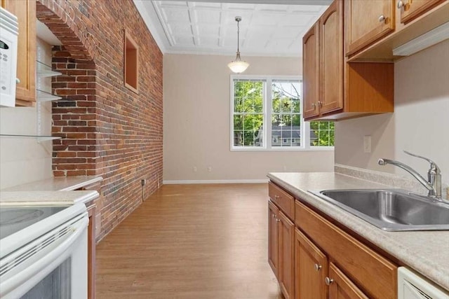 42 Phillips Rd Unit 1, Holden, MA 01520 - kitchen featuring brick wall, light wood-type flooring, a sink, decorative light fixtures, and brown cabinets