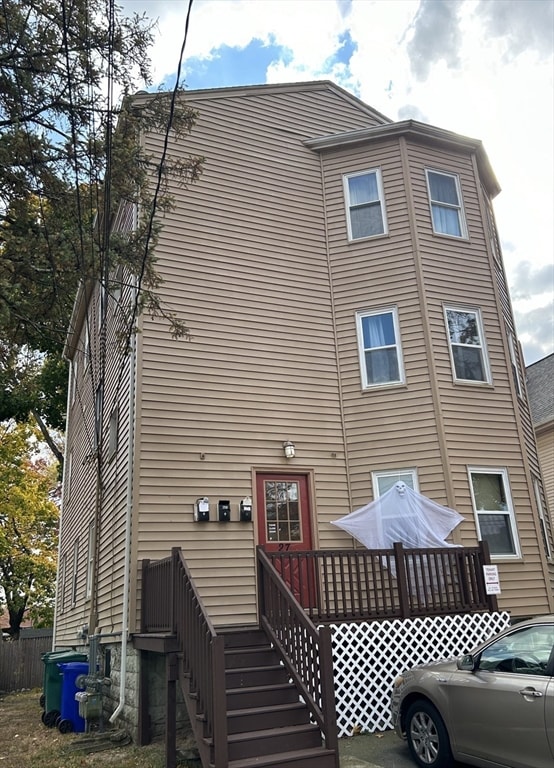 rear view of property featuring a deck