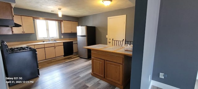 50 Clark St Unit 12, Fall River, MA 02720 - kitchen featuring freestanding refrigerator, dishwasher, light wood finished floors, gas stove, and a sink