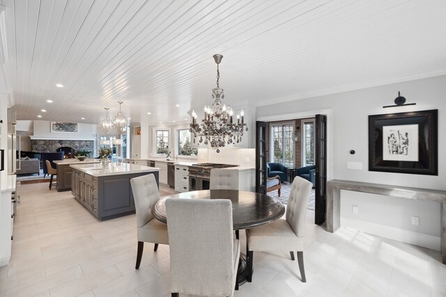 tiled dining room featuring wooden ceiling, a notable chandelier, ornamental molding, and a premium fireplace