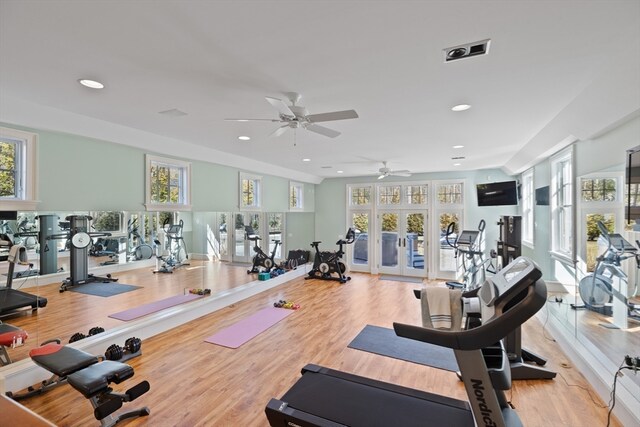 exercise room featuring french doors, light hardwood / wood-style floors, and ceiling fan