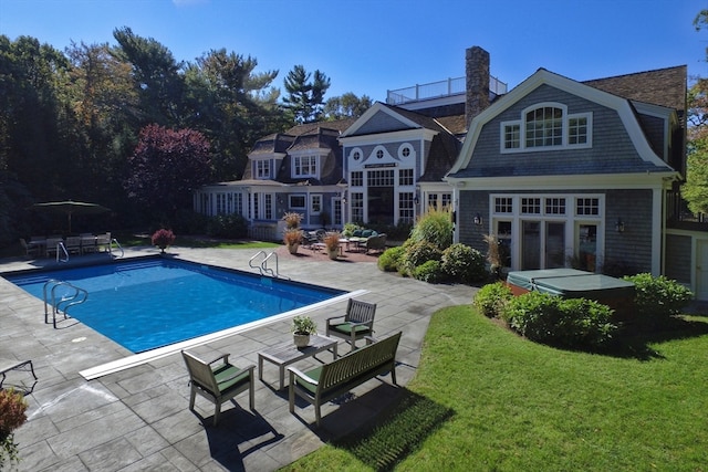 view of pool featuring a lawn and a patio