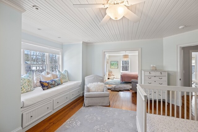 bedroom with ceiling fan, crown molding, and light wood-type flooring