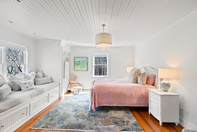 bedroom with a chandelier, wood ceiling, and dark hardwood / wood-style flooring